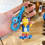 Llavero dinosaurio skate y guitarra correa de goma - Imagen 3